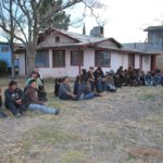 Este grupo numeroso de migrantes fue reunido en la cochera de una casa después de haber sido encontrados por las autoridades.